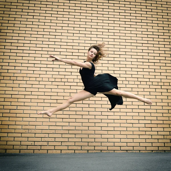 Girl in black dress dancing — Stock Photo, Image