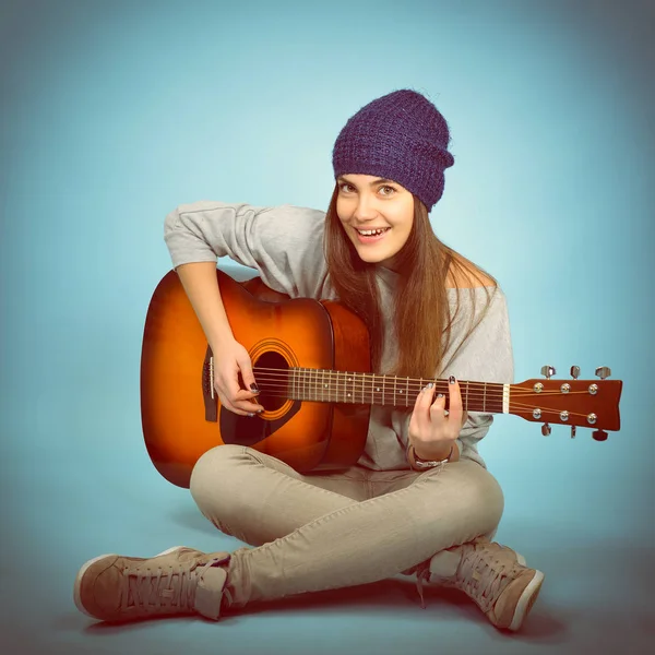 hipster woman playing on guitar