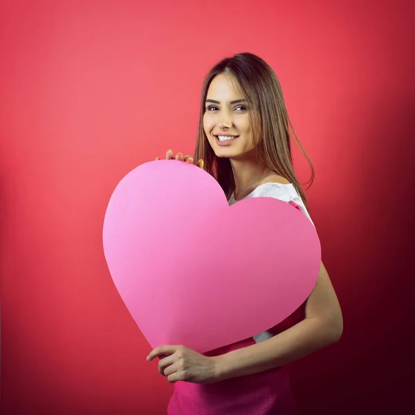 Mujer sosteniendo corazón rosa —  Fotos de Stock