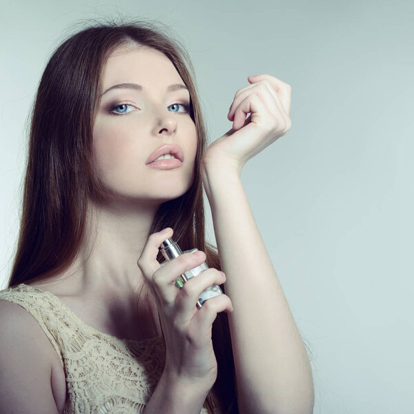 Lady holding bottle of perfume