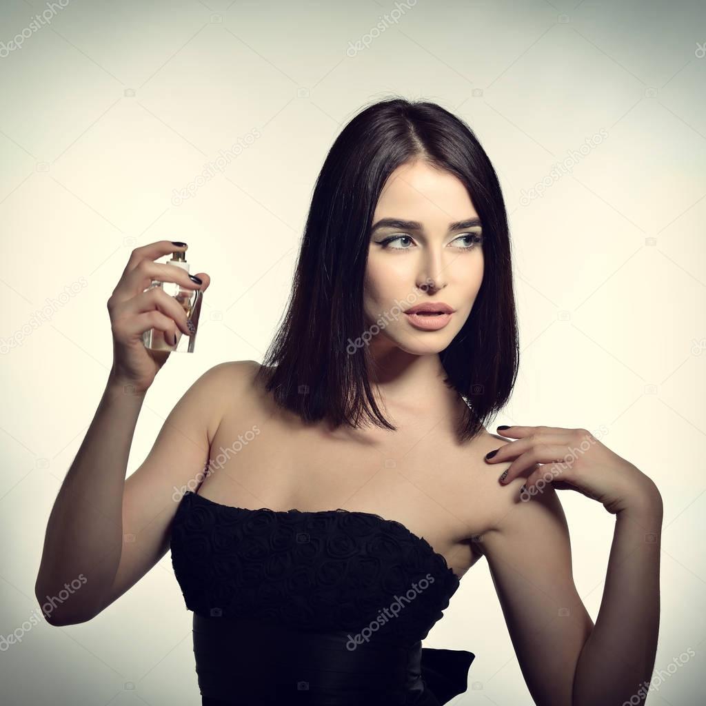 Lady holding bottle of perfume