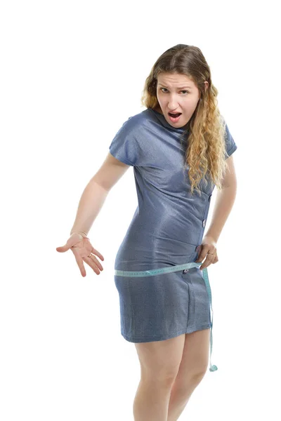 体重超标的年轻女子在白色背景下测量她的腹部 — 图库照片