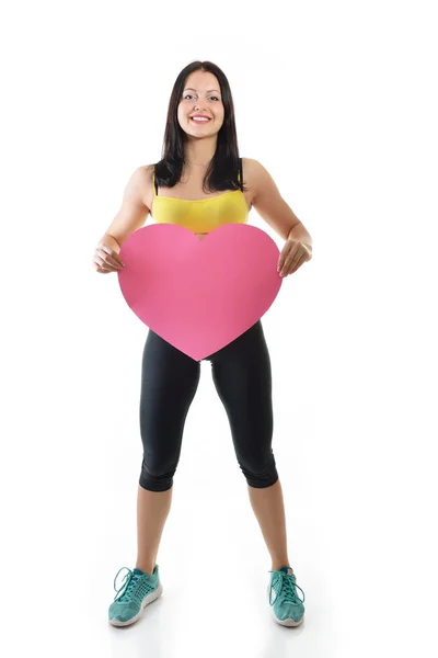 Fitness woman with pink heart — Stock Photo, Image