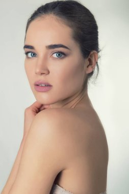 Avuç içi ile yüzünü dokunaklı güzel ve genç birbayan. Güzellik kadın