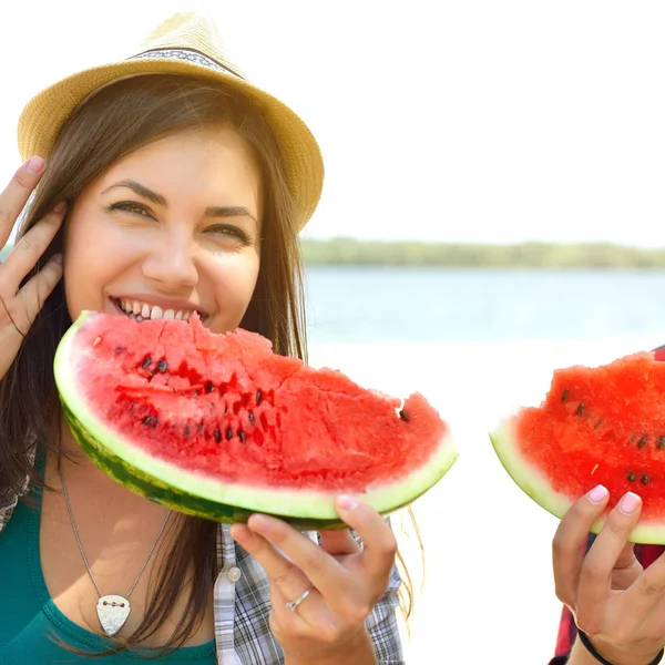 Gelukkige jonge paar watermeloen te eten op het strand. Jeugd lifesty — Stockfoto