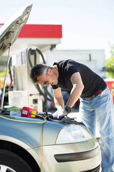 Oil change in car. Man repairing the engine in the car. Self-cha