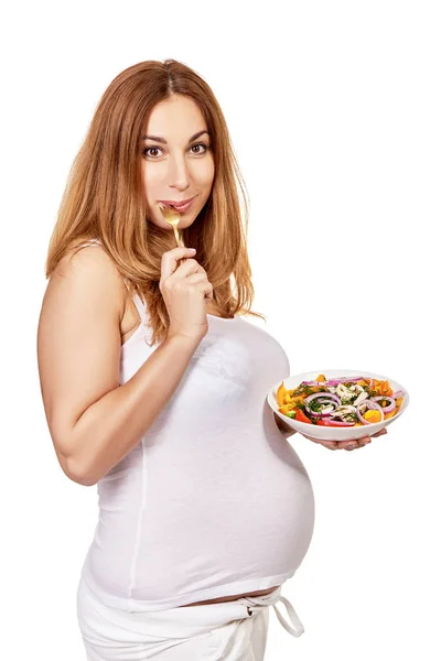 Una mujer embarazada. Retrato de comer embarazada posando en studi —  Fotos de Stock