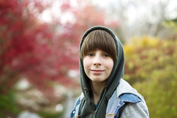 Retrato de rapaz bonito ao ar livre. Adolescente menino com capuz durante a primavera — Fotografia de Stock