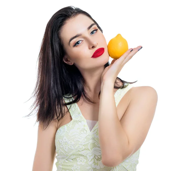 Excited beautiful girl holding lemon and posing in studio over w — Stock Photo, Image