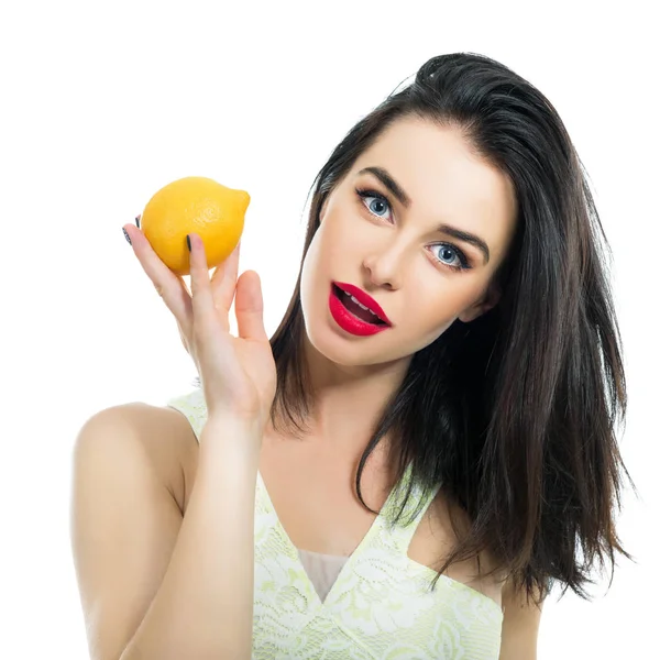 Excited beautiful girl holding lemon and posing in studio over w — Stock Photo, Image