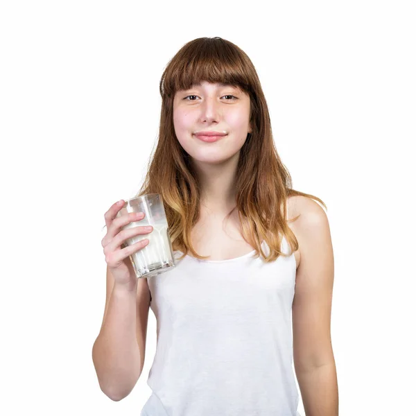 Gelukkig lachend tiener meisje consumptiemelk op witte achtergrond. — Stockfoto