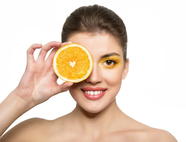 Beautiful young happy smiling woman holding half of orange with — Stock Photo, Image