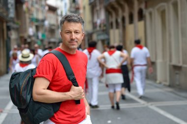 Man in celebrating San Fermin festival in traditional white abd  clipart
