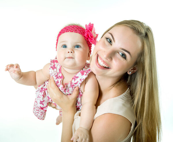 Young mother with her baby daughter happy smiling, studio portra