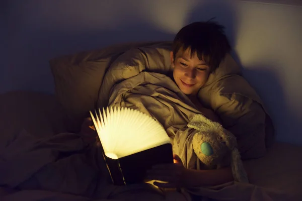 Adorable Boy Reads Book Sleeping Bed Home Childhood — Stock Photo, Image