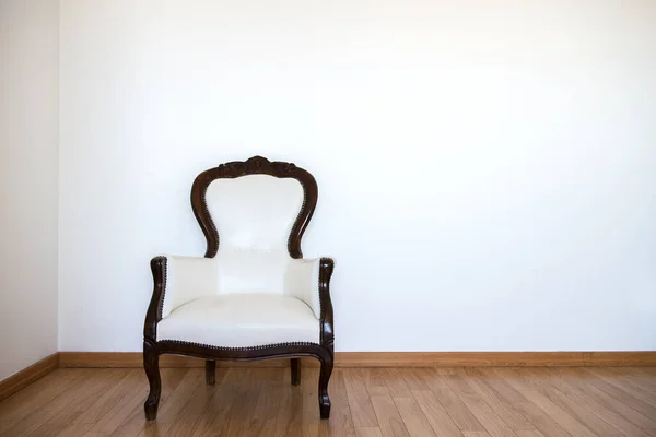Empty room with armchair and white wall. Abstract accommodation. Minimalism in lodging.