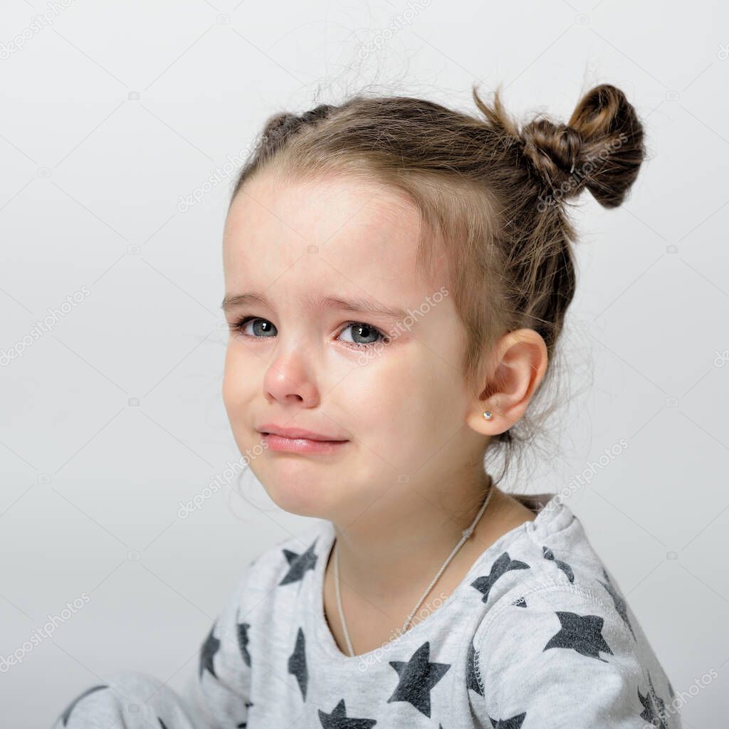 Crying little girl. Upset kid. Sad kid portrait. Cute little gilr crying and does not want to go in bed at night