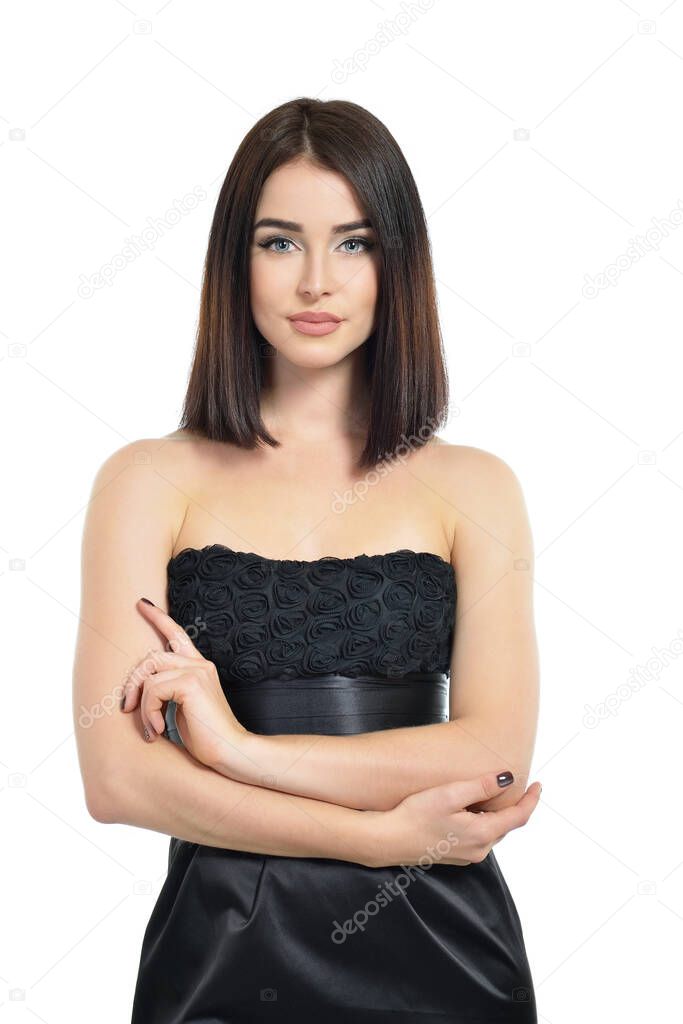 Beauty. Portrait of attractive young woman over white background. Amazing girl wearing black dress with perfect makeup isolated on white background.