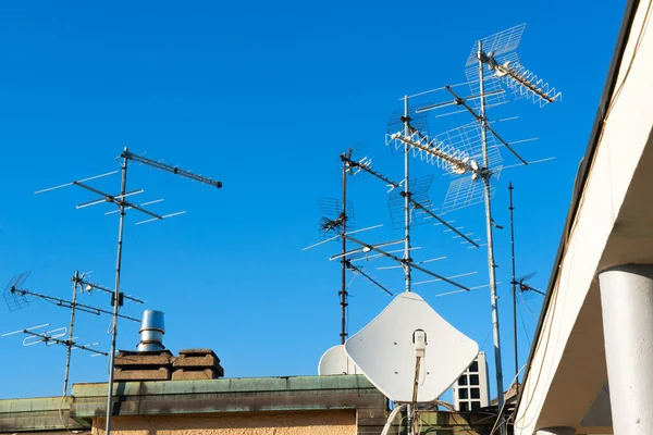 Antennas of satellite and analog television on the roof.