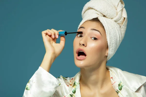 Giovane Donna Attraente Mettendo Mascara Occhio Sfondo Blu Mattina Trattamento — Foto Stock