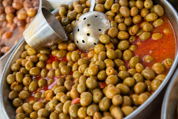 Selective large pickled olives in brine in outdoor market