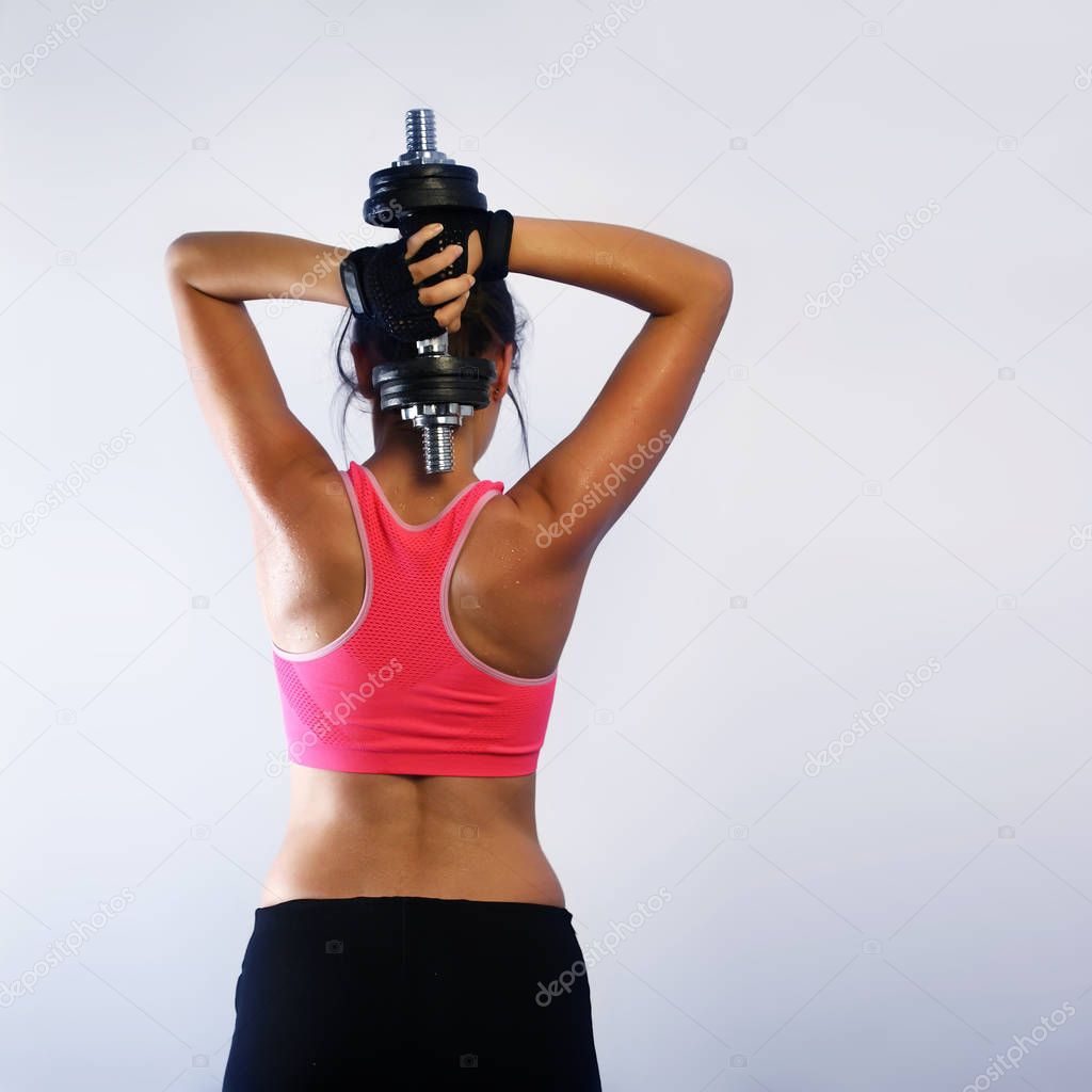 Fit woman lifting a dumbbell