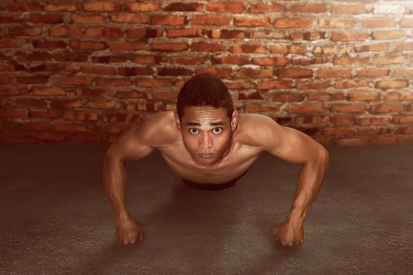 Man push up on brick wall background