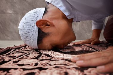 Muslim man praying in mosque clipart