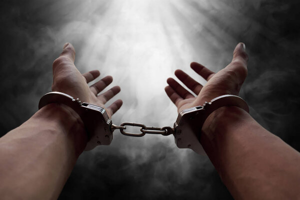 Hands of prisoner in handcuffs