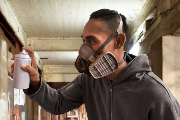 Graffiti artist wearing respirator mask