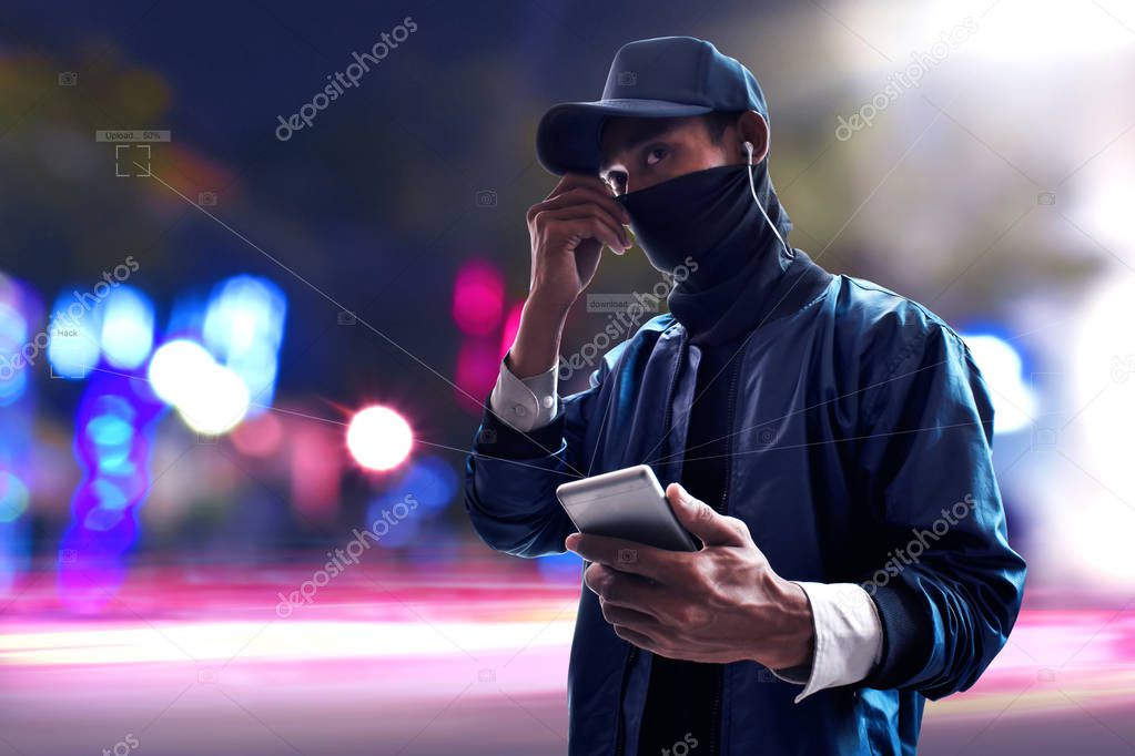 Hacker using mobile phone on the street
