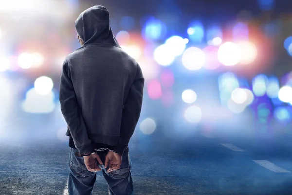 Hacker in handcuffs on the street — Stock Photo, Image
