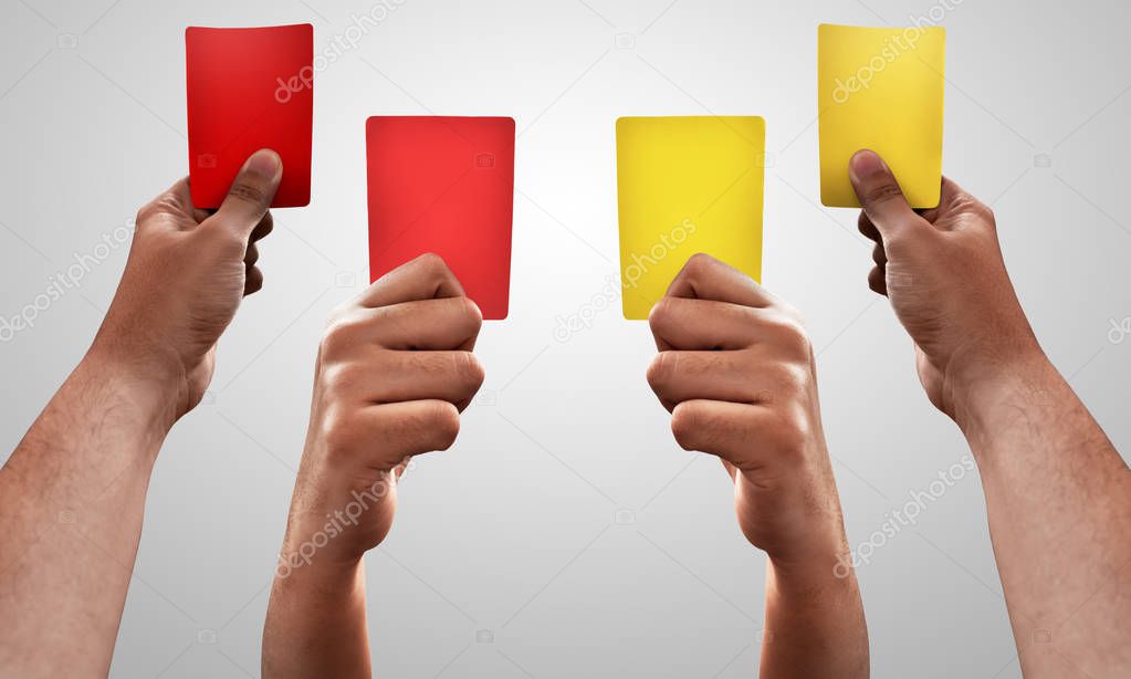 Set of hands holding red and yellow card