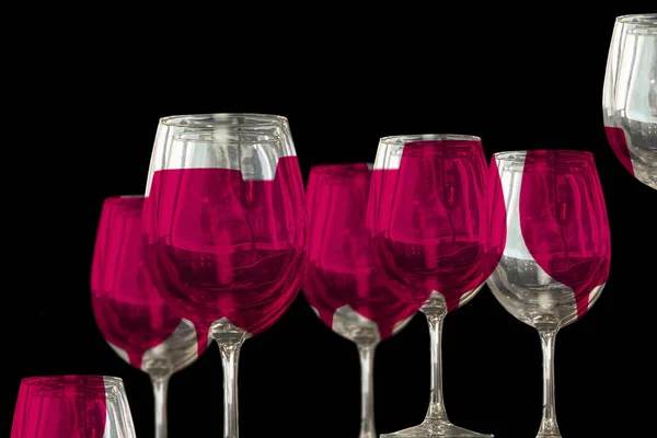 Red wine on wine glasses isolated on black — Stock Photo, Image