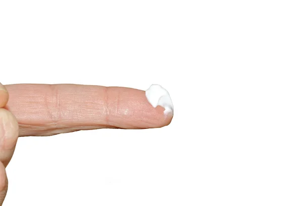 Cream on finger — Stock Photo, Image