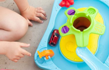 Çocuk eli renkli su oyunuyla oynuyor