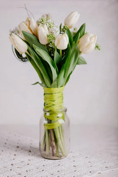 Bouquet of white tulips with lilac in vase