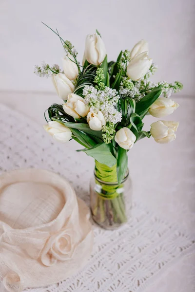 Bouquet of white tulips with lilac in vase