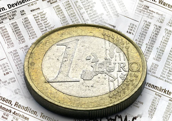 Euro coin in close up with stock market data — Stock Photo, Image
