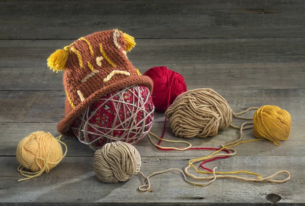 Balls of yarn and a hat — Stock Photo, Image