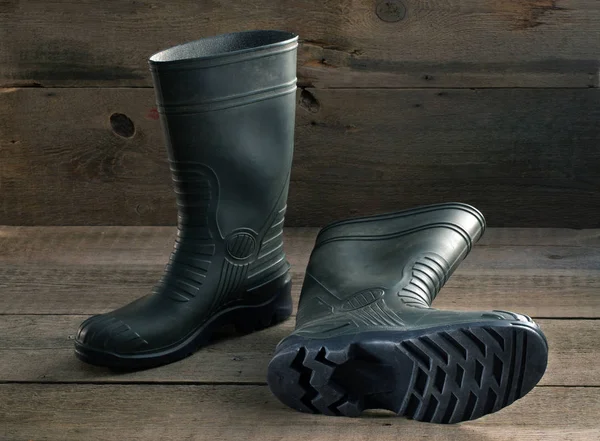 Men's rubber boots on the wooden floor — Stock Photo, Image