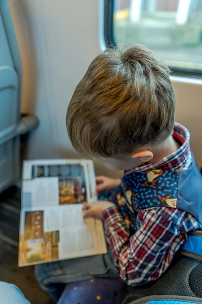Travel concept of boy reading on train journey