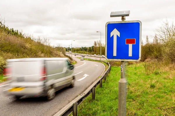 Day view background of UK Motorway Road Sign