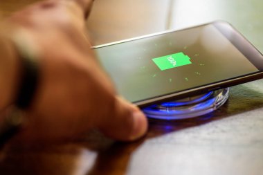 Şarj bir yastık üzerinde şarj Smartphone. Kablosuz şarj
