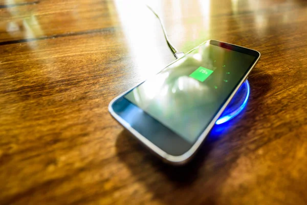 Smartphone charging on a charging pad. Wireless charging