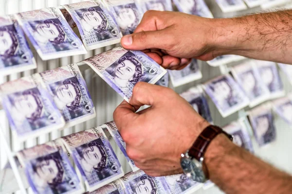 İngiliz Sterlini Pound üzerinde insan eli notlar üzerinde elbise kurutma makinesi. Para aklama kavramı