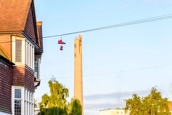 Pair of boots hanging on power lines in English Town