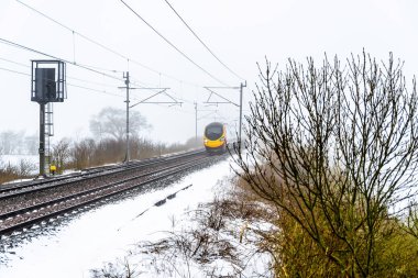 İngiltere'de İngiltere'de demiryolu bulutlu sisli kış gün görünümü tren. Emma fırtına tren manzara.