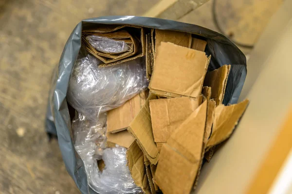 cardboard waste in plastic bag on construction site