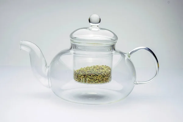Fennel seeds loose inside glass teapot ready to be brewed for healthy drink on white background — Stock Photo, Image